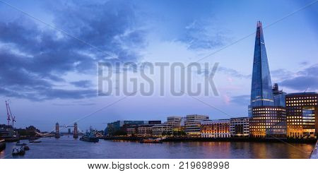 Panoramic London skyline with The Shard skyscraper located on the south bank of the River Thames in  Southwark as viewed from the London Bridge at night