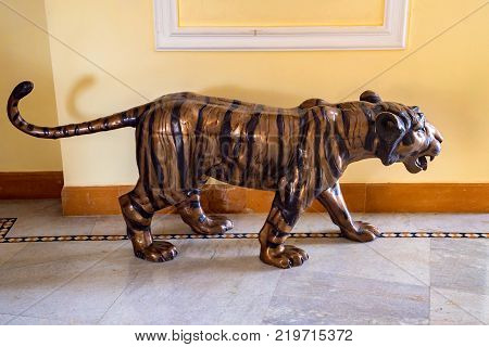 Close up image of statue of tiger on the floor indoors used as interior decorative detail