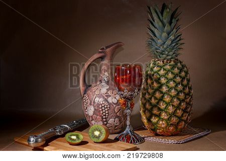 Tropical fruit and a jug on the table display.