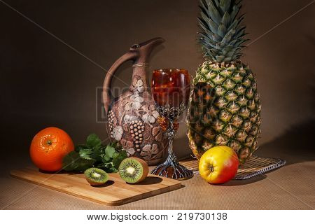 Tropical fruit and a jug on the table display.