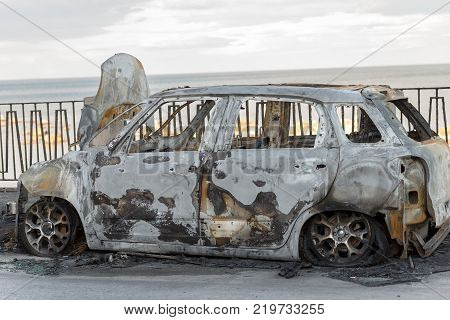 Small utilitarian car burned and parked in a street