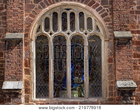 Window with a stained-glass window in the old church. Downtown Exeter. Devon. UK
