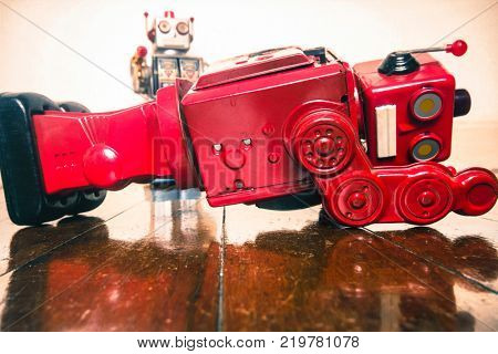 shot down concept with retro tobot toys on a wooden floor with reflection