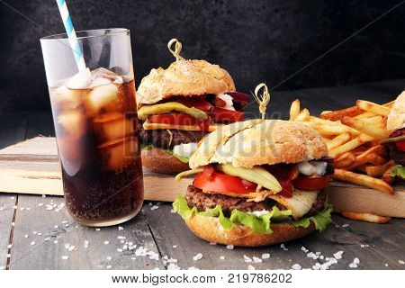 Homemade burger and cheese with fries and icy soft drink