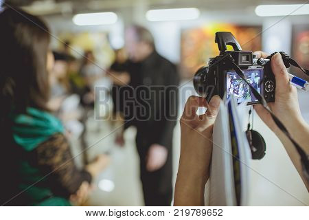 Male celebrity being photographed at media event