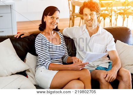 Couple with papers in their living room