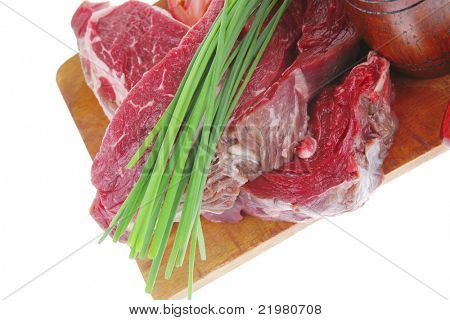 meat portion: bloody beef fillet on plate with cutlery served before cooking