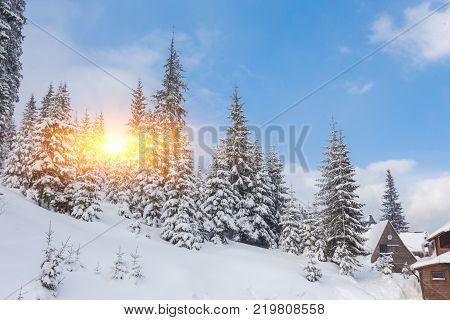 Winter resort with slopes for skiing and snowboarding with houses and lifts