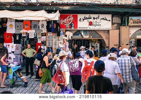 JERUSALEM ISRAEL - AUGUST 05 2010: Horizontal picture of people moving at the souks the market in Arab Quarter inside the walls of Old City in Jerusalem Israel