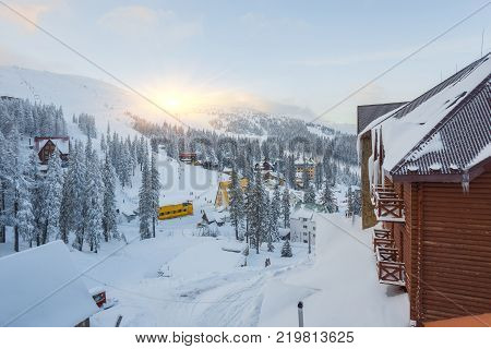 Winter resort with slopes for skiing and snowboarding with houses and lifts