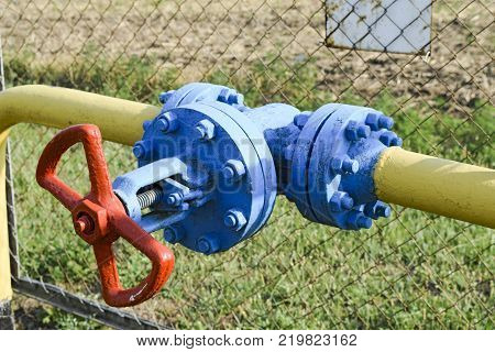 The latch on the underground gas pipeline protected with a fence.