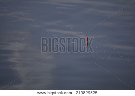 the moon in the late evening sky over the lake
