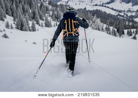 A snowshoe is footwear for walking over snow. Snowshoes work by distributing the weight of the person over a larger area so that the person's foot does not sink completely into the snow