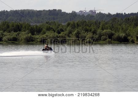 floats Young guy cruising on the atlantic ocean on a jet ski