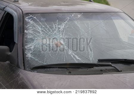 Broken side window in a car.  shattered glass