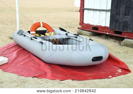Inflatable Rescue Boat. Gray inflatable boat on the beach in the sand.
