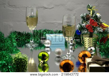 Champagne glasses Christmas tree Christmas gifts and Christmas balls on black background