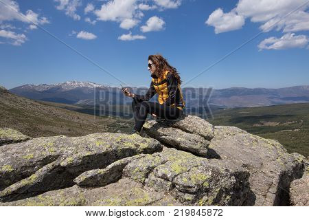 Woman On Top Of Mountain Typing Mobile