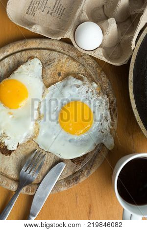 Topdown on Fried Eggs with Black Bread and Coffee