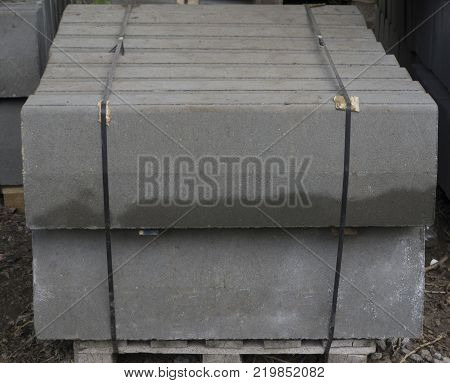 the dark one Stack of concrete curbstone. Construction process