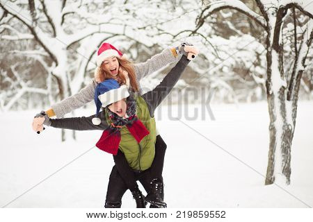 Young people are making fun on winter day. Carefree time.