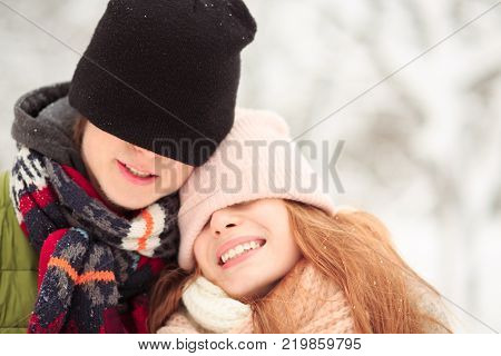 Young people closed eyes with their hats. They remember their first date.