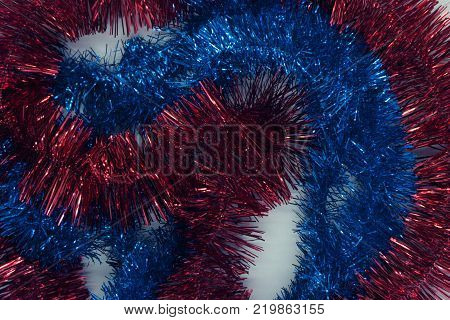 Colorful Christmas tinsel. New year's fluffy gold tinsel blue and yellow star tinsel and pink tinsel. Sparkling ornament decoration concept