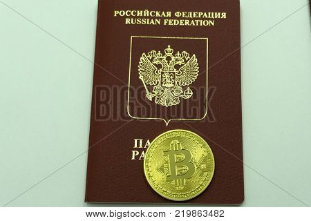 Golden bitcoin on passport as national emblem of Russian Federation