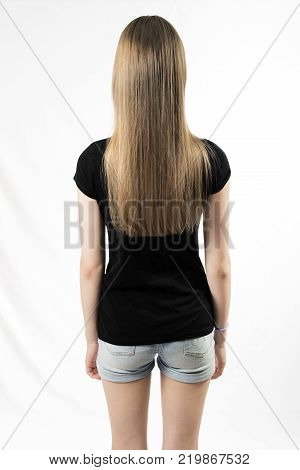 Girl stands with her back to the photographer, isolated on white