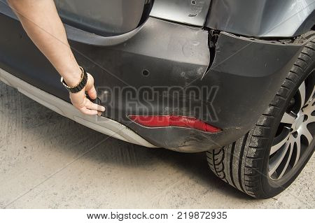 A car has a dented rear bumper after an accident
