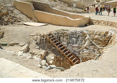 Luxor, Egypt - November 13. 2006: Tourists in the Valley of Kings near Luxor. Travel in Egypt, famous Egyptian landmarks. Archaeological research in the mountains of the Valley of the Kings in the ancient Egyptian capital of Thebes