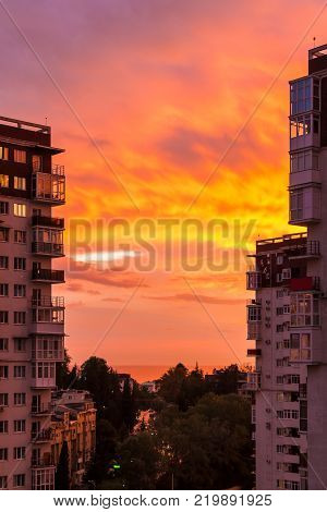 Aerial view of Tonnelnaya street between two apartment buildings and beautiful sky at sunset, Sochi, Russia