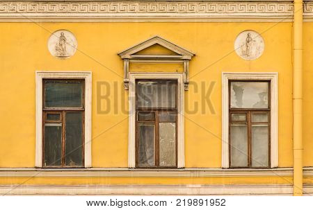 Three windows in a row on the facade of the urban historic building front view, Saint Petersburg, Russia