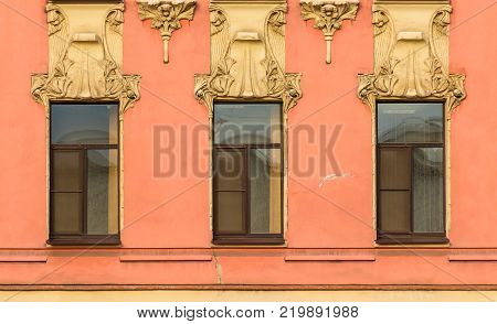 Three windows in a row on the facade of the urban historic building front view, Saint Petersburg, Russia