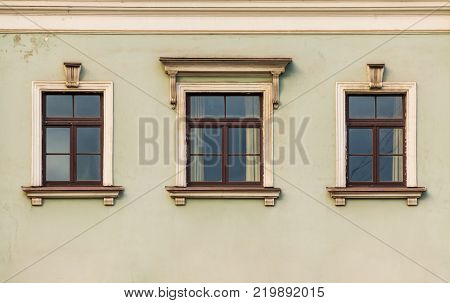 Three windows in a row on the facade of the urban historic building front view, Saint Petersburg, Russia