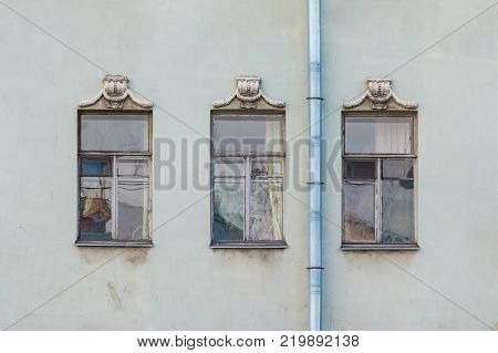 Three windows in a row on the facade of the urban historic building front view, Saint Petersburg, Russia