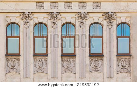 Several windows in a row on the facade of the urban historic building front view, Saint Petersburg, Russia
