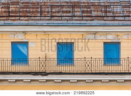 Three windows in a row on the facade of the urban historic building front view, Saint Petersburg, Russia
