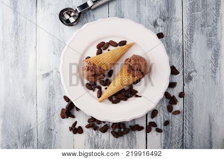 chocolate ice cream scoops with pieces of chocolate and waffle cones