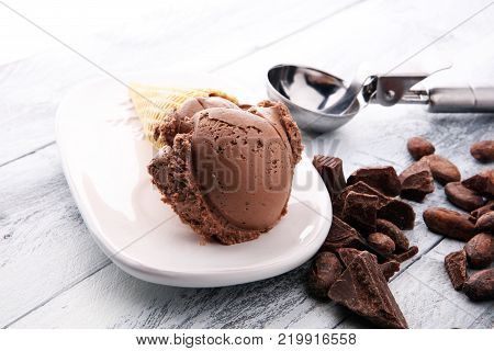 chocolate ice cream scoops with pieces of chocolate and waffle cones