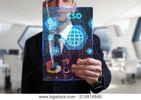 Business Technology Internet and network concept. Young businessman working on a virtual screen of the future and sees the inscription: CSO