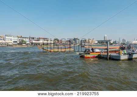 BANGKOK THAILAND - December 22 2017: Chao Phraya River and Long Tail Boat Tourist Peer. Long-tail boat is very popular transportation for people or tourists traveling and visiting place along the riverside in Thailand.