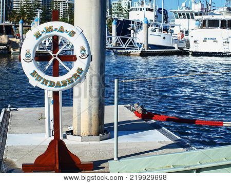 Gold Coast Australia - July 25. 2010: The ceremonial life ring from Warship Bundaberg positioned on the Southport Yacht Club Marina wharf next to the ship's boarding ladder during a visit to the Gold Coast in Main Beach Gold Coast Queensland Australia.
