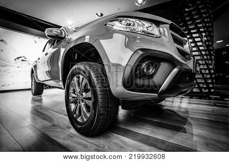 BERLIN - DECEMBER 21, 2017: Showroom. Mid-size luxury pickup truck Mercedes-Benz X-Class X220d 4Matic. Black and white. Since 2017.