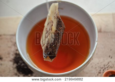 Tea bag and healthy red tea in the tea cup/ top view