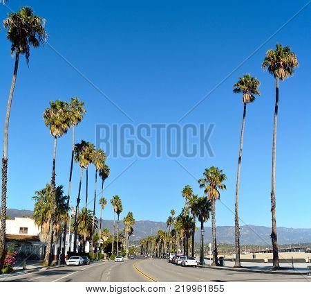 Santa Barbara, California, United States of America - November 30, 2017. View of State St in Santa Barbara, CA, with residential buildings, cars and palm trees.