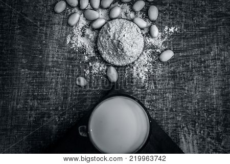 Close Up Of Ayurvedic Herb Kuanch,cowhage,mucuna Pruriens With Powder And Milk Glass.;