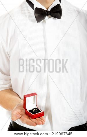 18 year old wearing a tuxedo holding a ring box isolated on a white background