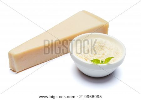 a piece of Parmesan cheese on white background with grated in ceranic bowl