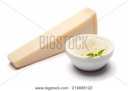 a piece of Parmesan cheese on white background with grated in ceranic bowl